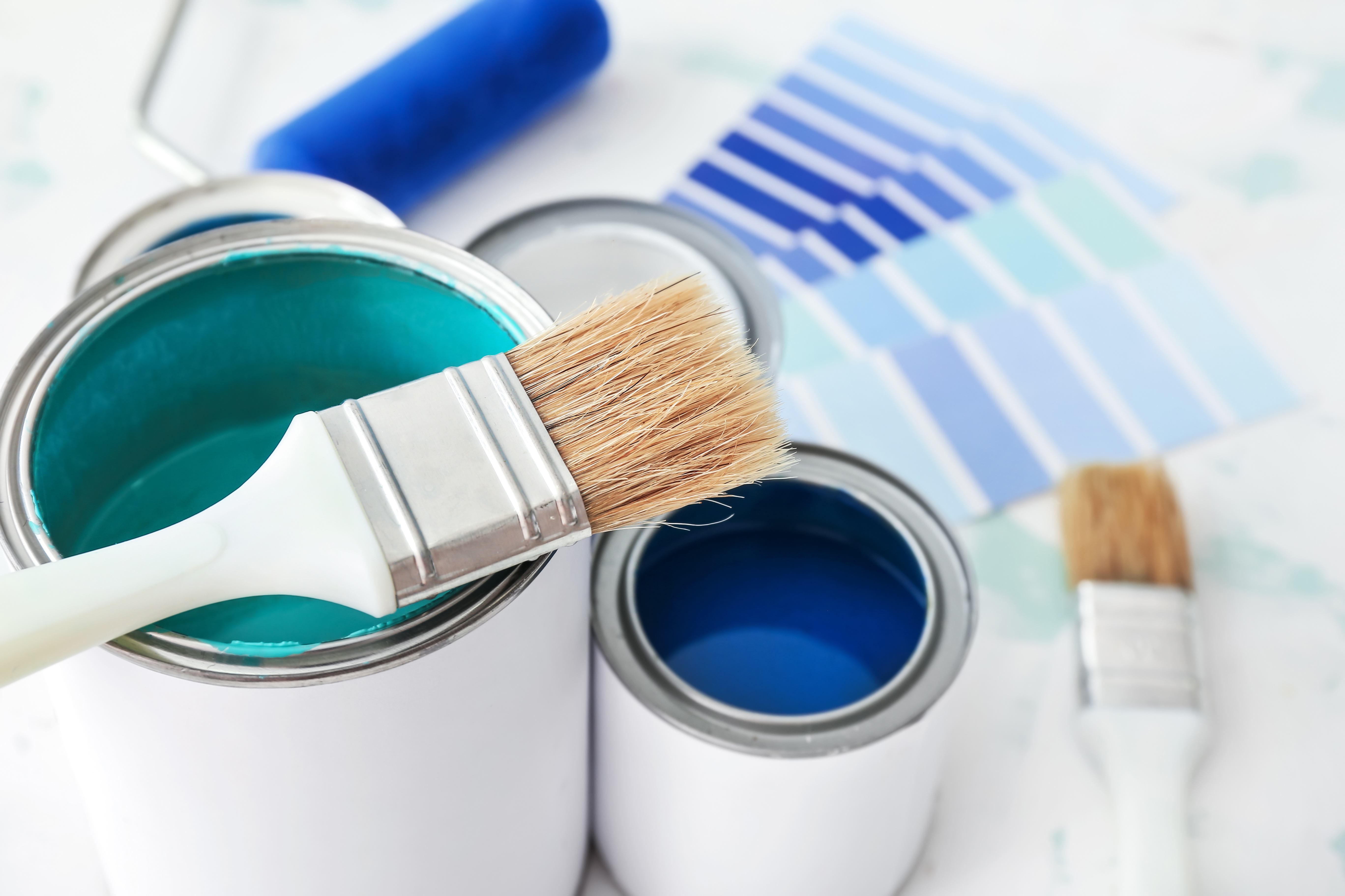 Paint is easy. Cans, brushes and swatches hint at the fun.