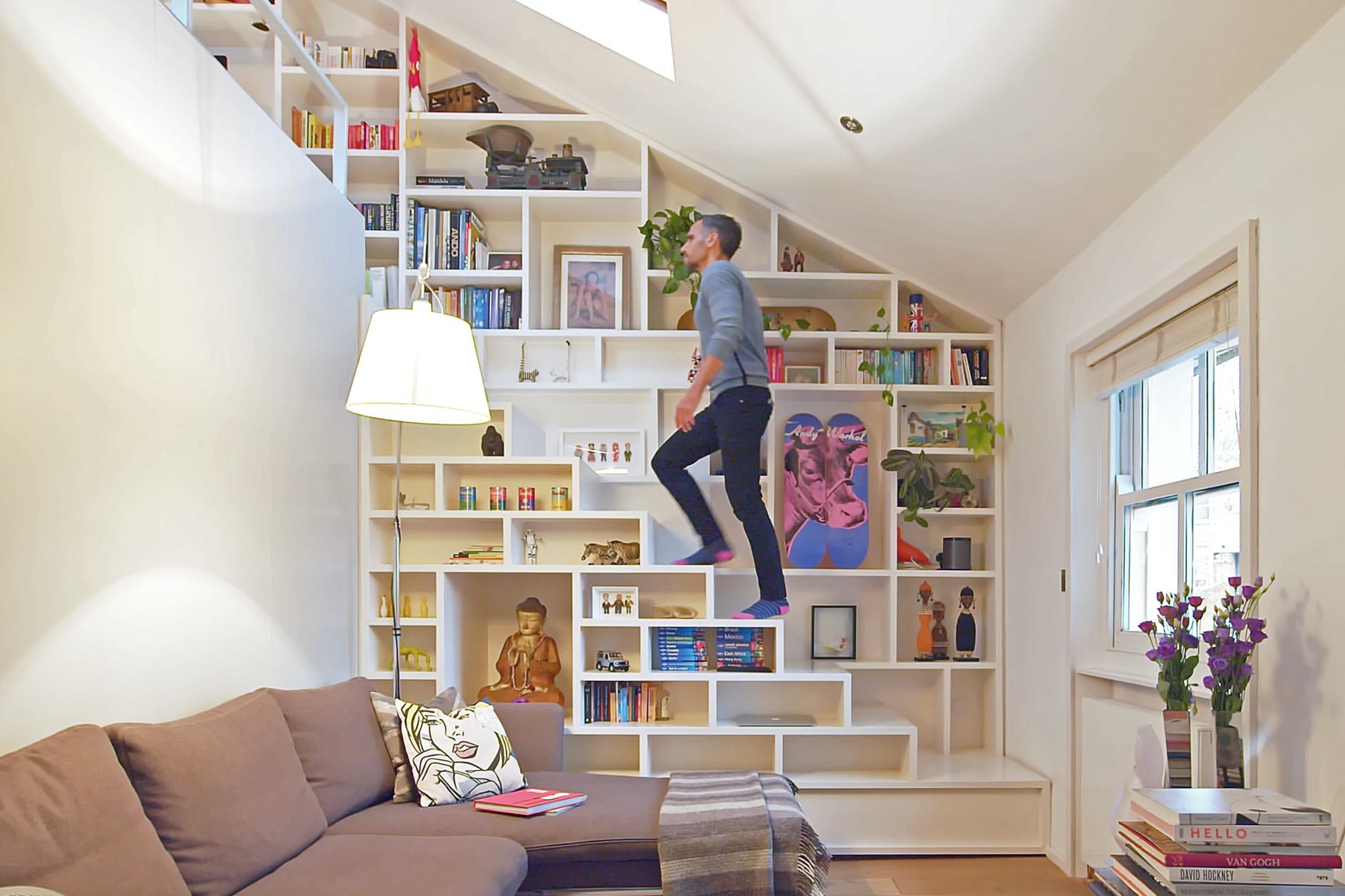 Wall and stairway completely made of bookshelves in Never Too Small on Youtube