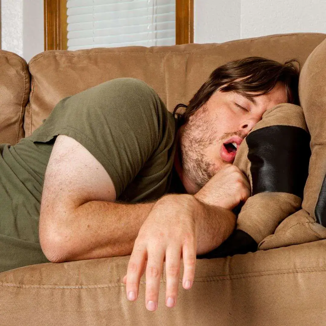 Man Snoozing Adobe Stock Man snoozing on sofa toss pillow with mouth open