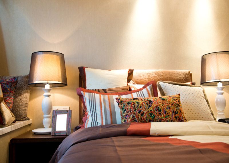 Unknown Author Bed pillows Bed with six pillows with strong color and very different patterns for each to the point they don't relate well in each other