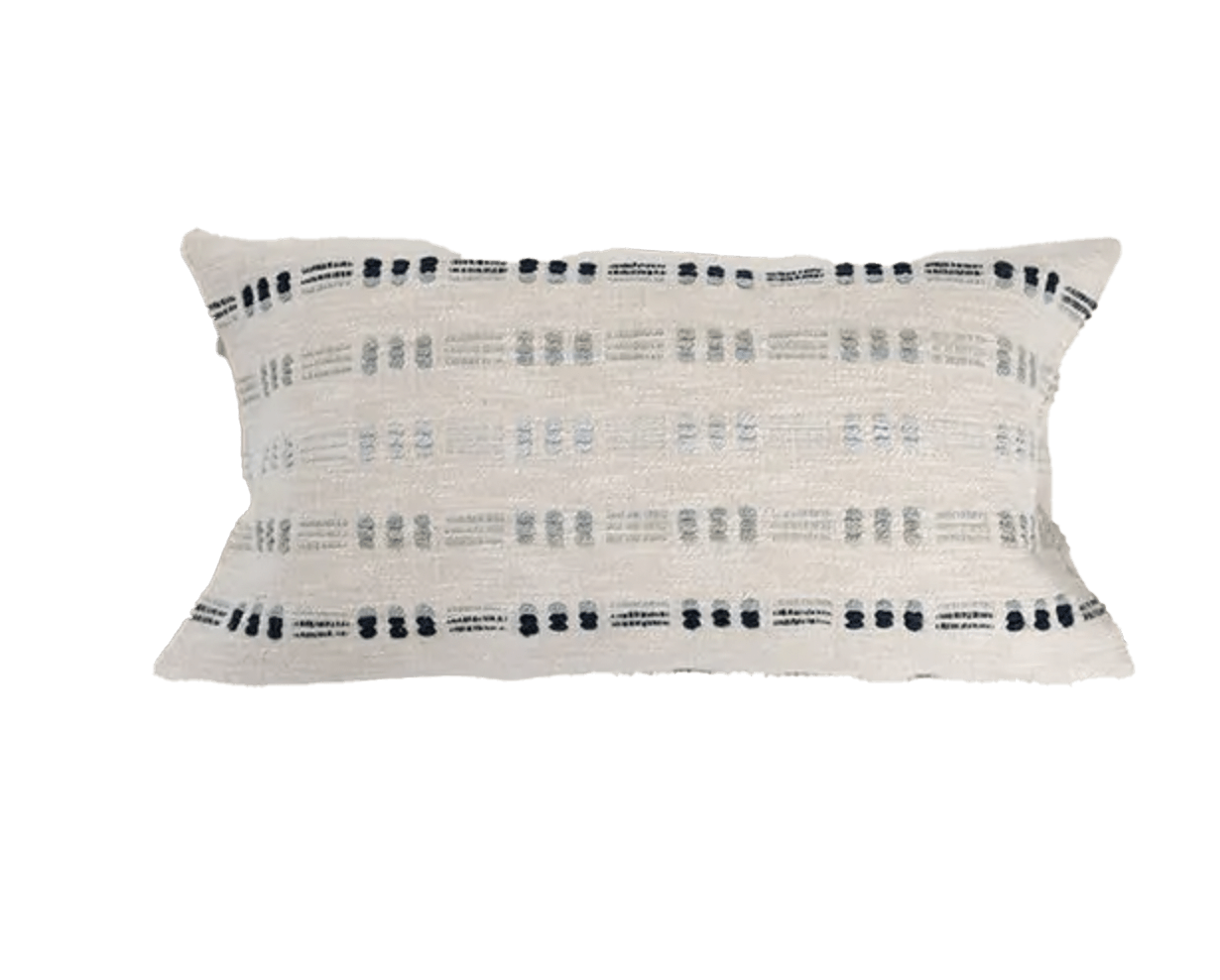 Small rectangular white pillow with horizontal stripes made by stitching in different colored blue embroidery in a dash pattern