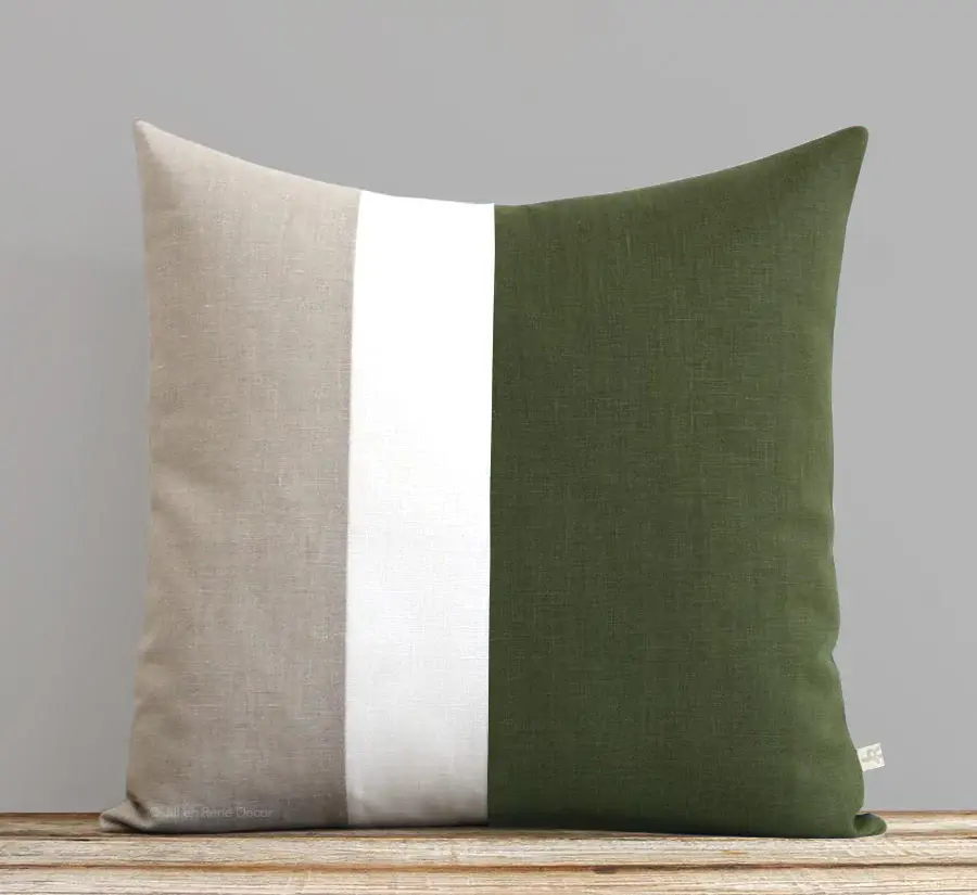 Square throw pillow with vertical color blocking in taupe, white, and olive green linen.