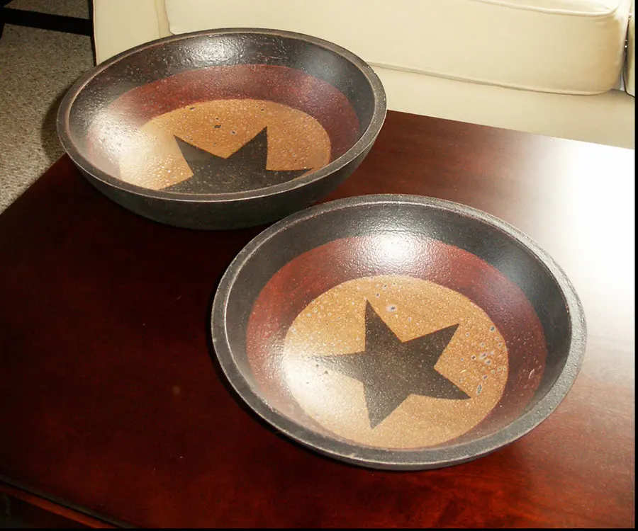Decorative star-pattern bowls on dark wood coffee table beside cream sofa in living room